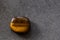 Polished tigereye gemstone on a black background
