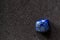 Polished tumbled lapis lazuli stone on a black background