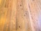This is a polished wood floor suitable for background.