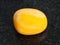 polished yellow jasper gemstone on dark