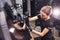 Polishing surface of vehicle. Modern black automobile get cleaned by woman inside of car wash station