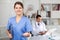 Polite female health worker meeting patient in office