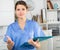 Polite female health worker meeting patient in office