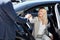 Polite taxi driver help business woman get out of car