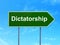 Political concept: Dictatorship on road sign background