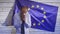 Politician loser. Young palatik crying against the background of the European flag. Funny politician screwed up.