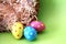 Polka dot Easter eggs lying in straw