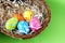 Polka dot Easter eggs lying in straw