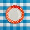 Polka dot red white dinner plate on blue checked