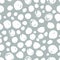 Polka dot seamless pattern. Hand drawn artistic ink circles. White blobs on grey background.