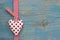 Polka dotted heart on blue wooden surface in country style for g