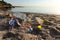 Polluted Beach With Plastic Garbage Lying On Sand Near Water