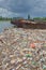 Polluted river bank full of garbage