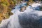 Polluted river, foam on the water surface top view