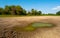 Polluted water and cracked soil of dried out lake