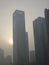 Pollution in Beijing -- Sun Shinning in Smoggy Haze Behind Skyscraper