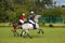 Polocrosse players on their horses