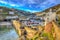 Polperro Cornwall England with houses and harbour wall in HDR like painting