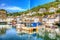 Polperro harbour Cornwall England with clear blue and turquoise sea in vivid colour HDR like painting