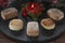 Polvorones and lighted decorative red candle on round slate plate