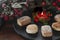 Polvorones and lighted decorative red candle in upper right corner on a slate plate