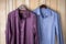 a polyester shirt next to a silk shirt on a wooden hanger