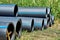 Polyethylene pressure pipes for water supply pipes with wooden struts to preserve the diameter lie on the grass