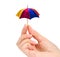 Polygonal hand studio photo keeps color umbrella in the fingers