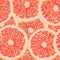 Polygonal vector illustration of a grapefruit slice seamless pattern