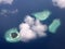 Polynesia. The atoll in ocean through clouds.