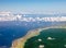 Polynesia. The atoll in ocean through clouds.