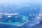 Polynesia. The atoll in ocean through clouds. Aerial view.