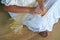 Polynesian Cook Islander woman weaving a hand fan in Rarotonga C