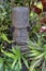 Polynesian female figurine wooden carving sculptur in a tropical