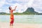 Polynesian hula dancer woman dancing on Bora Bora beach Hawaii traditional dance for luau party. Happy Asian tourist