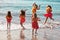 Polynesian Hula girls in jumping in the ocean