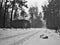 Polythene Tack lying in snowy path leading around empty house in czech republic