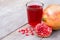 pomegranate fruit and glass of pomegranate juice .