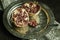 Pomegranate fruit and grains separated from the pomegranate itself in a spoon on silver tray