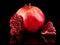 Pomegranate fruit. Pomegranates over black Background. Organic Bio fruits