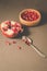 pomegranate fruit, the purified pomegranate seeds in a wooden bowl/Pomegranate fruit and grains in a wooden bowl and a spoon