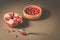 pomegranate fruit, the purified pomegranate seeds in a wooden bowl/pomegranate fruit, the purified pomegranate seeds in a wooden