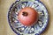 Pomegranate lies in a bowl with a traditional pattern