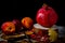 Pomegranate, nectarines and fallen leaves on a wooden background.