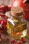 Pomegranate oil in a glass bottle macro. vertical