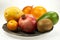 Pomegranate, papaya, mango - a set of exotic fruits on metal plates. Studio, isolated
