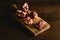 Pomegranate pieces on a cutting board on a dark background