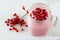 Pomegranate raspberry smoothie in mason jar glass over marble