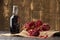 Pomegranate, scattered seeds and pomegranate juice on a wooden background