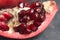 Pomegranate Slice Fruit. Close up Granate Seeds in slice. Macro image. vitamine and Healthy concept. Gray Textured Background.